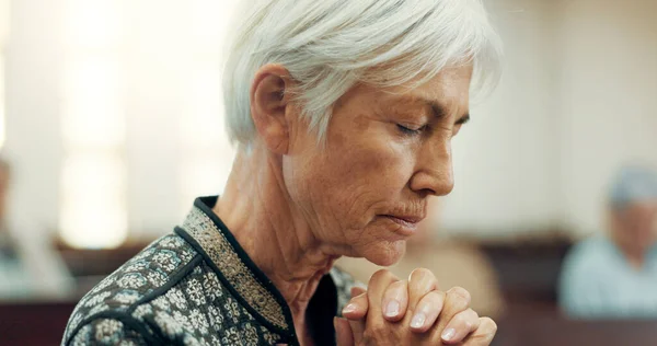 Senior, prayer or old woman in church for God, holy spirit or religion in cathedral or Christian community. Faith, spiritual or face of elderly person in chapel or sanctuary to praise Jesus Christ.