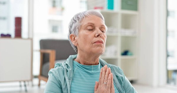 Yoga, namaste meditation and woman breathing for mindfulness, senior exercise or healing at home. Face of healthy old lady, breathe and meditate with prayer hands for zen, wellness and focus on peace.