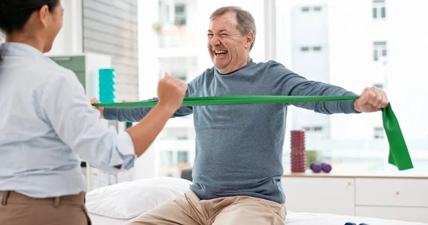 Physiotherapy, stretching band and senior man for doctor support in physical therapy, rehabilitation or healthcare. Medical woman or chiropractor consulting elderly patient for muscle health services.