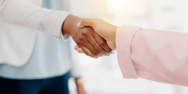 Business people, handshake and partnership for b2b, meeting or trust in teamwork at the office. Colleagues shaking hands in unity, deal or agreement for greeting, welcome or introduction at workplace.