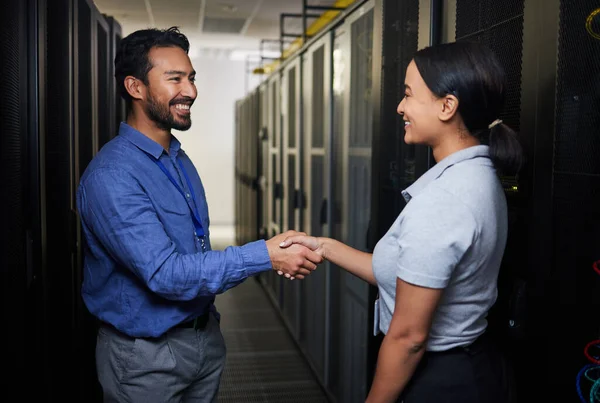 Handshake, partnership or happy people in server room of data center for network help with IT support. B2b deal agreement, teamwork or engineers shaking hands together in collaboration for solution.