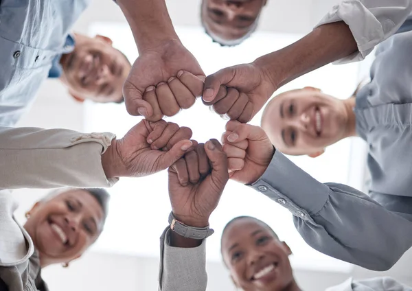 Hands fist bump, group circle and business people celebrate community support, synergy or happy corporate achievement. Below view, trust and staff commitment, solidarity and team building motivation.