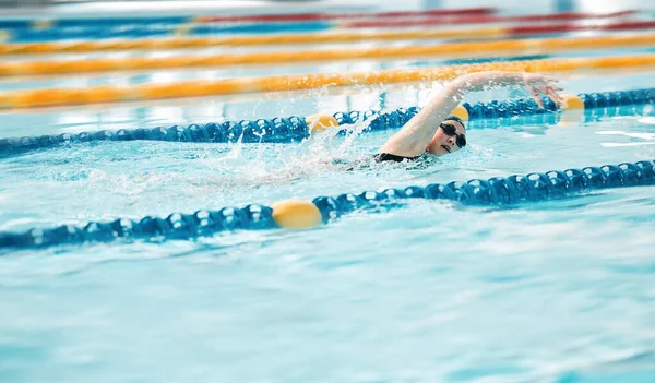 Stock image Swimming exercise, pool and sports person training for challenge, freestyle competition or performance workout. Gym club swimmer, water splash and active athlete cardio, race or practice stroke.