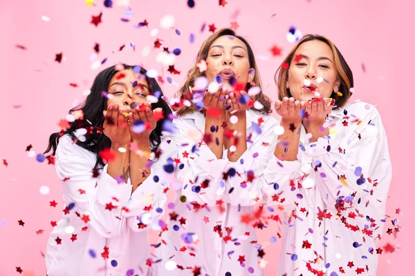 Blow, confetti and portrait of women in studio for celebration, underwear sale and discount. Beauty, diversity and female people on pink background for cosmetics, natural skincare and wellness.