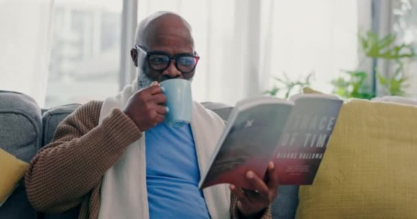 Кофе Зрелый Чернокожий Мужчина Чтение Книги Дома Диване Гостиной Счастливый — стоковое видео