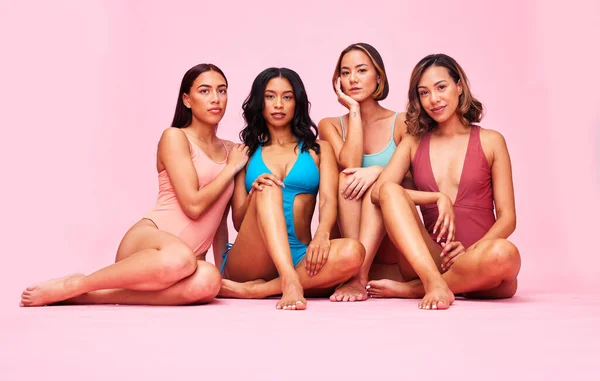 Bikini, portrait and group of women in studio isolated on pink background. Together, swimwear and friends with body positivity, inclusion or wellness for diversity in summer fashion at beach vacation.