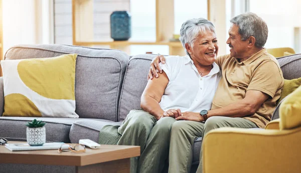 Love, relax and senior couple on sofa for bonding, healthy marriage and relationship in living room. Retirement, hug and happy man and woman on couch embrace for trust, commitment and care at home.
