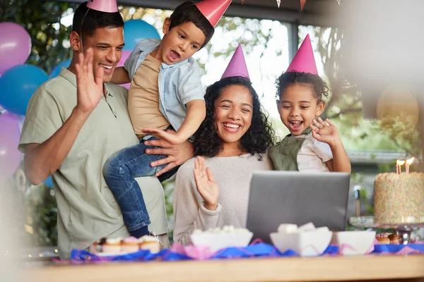 Family video call, birthday party and kids with laptop, cake or celebration for support, wave or happy in home. Child, flame and wish with contact, food and dessert with gift, hat or webinar at event.