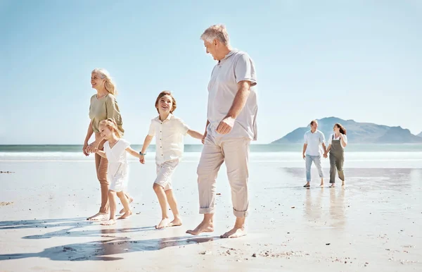 Grandparents, kids and holding hands on beach, family and parents with trust and support, tropical holiday and travel. Happiness, nature and sea with love and care, generations and people on vacation.