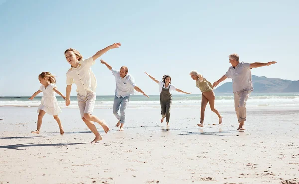 Running, freedom and family on beach, airplane and game with travel and fun, grandparents with parents and kids outdoor. Playful, energy and playing together, ocean and care free on tropical vacation.