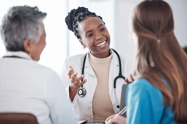 stock image Teamwork, doctors or happy woman in meeting or discussion for hospital planning or collaboration. Leadership, smile or nurses talking or speaking of medical healthcare research, report or news update.