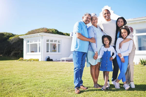 Happy family, portrait and real estate on garden grass in property, investment or moving in new home together. Parents, grandparents and kids smile in happiness for buying house, building and finance.