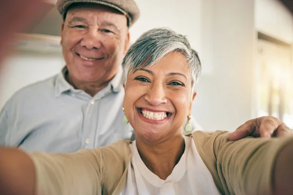 Senior couple, face and selfie in home for love, smile and relax to bond in retirement together. Portrait of happy woman, elderly man and profile picture for social media post, photography and memory.