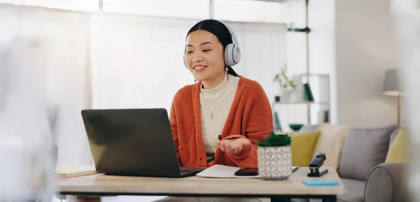 Woman on video call with work from home laptop, headphones and virtual international online meeting. Hello, wave and asian person in China in webinar for remote working or global update in computer.