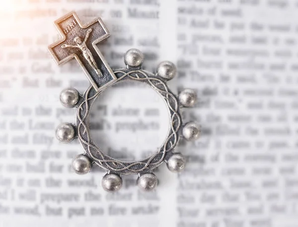 Rosary, open book or bible study for faith, studying religion or mindfulness with holy spiritual scripture. Christian literature, background or story for education or knowledge on God or Jesus Christ.