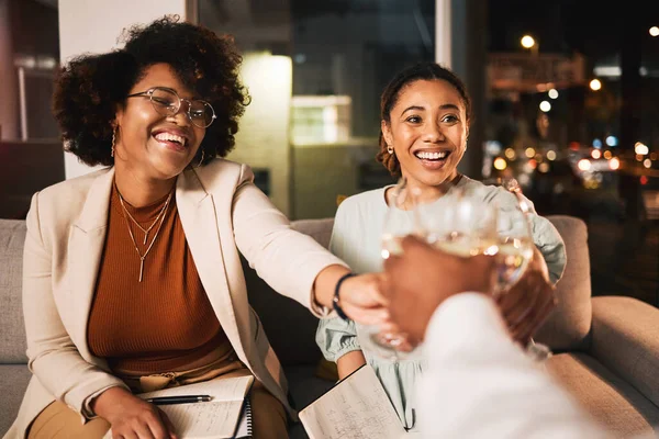 Black women, business people and night, wine and toast with celebration, deadline target or goals with happiness. Alcohol drink, party and winning, cheers and overtime with working late and meeting.