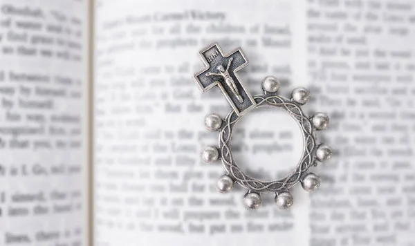 Rosary, open book or bible study for worship, religion or mindfulness with holy spiritual scripture. Christian literature, background or history education or knowkedge guide on God or Jesus Christ.