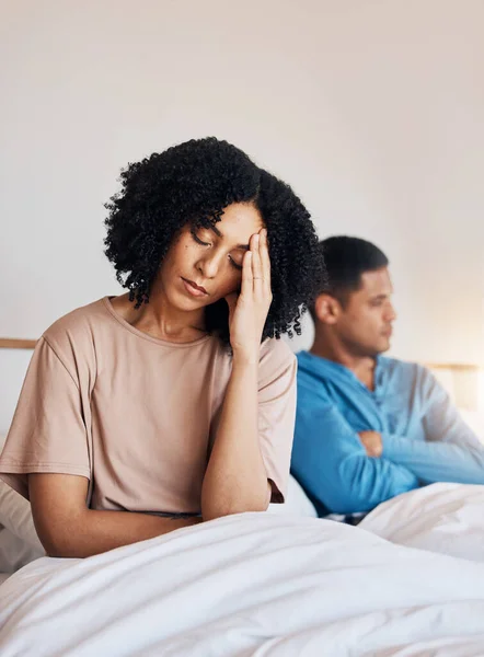 Frustrated couple, fight and headache in divorce, argument or disagreement from conflict or dispute at home. Upset woman and man in breakup, cheating affair or toxic relationship in bedroom at house.