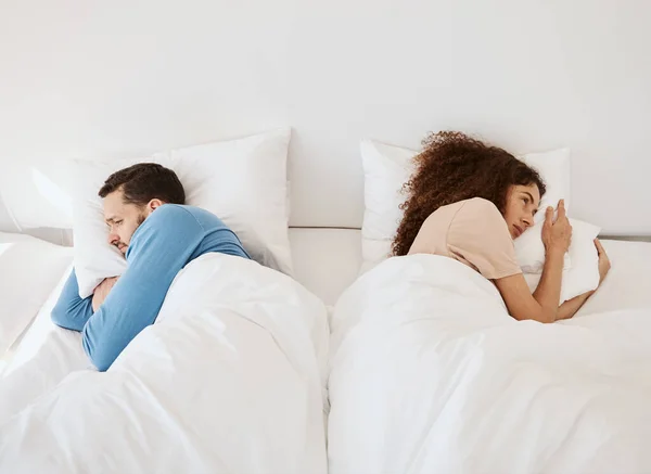 Divorce, ignore and angry couple in bed after fight, argument or dispute in their home from above. Marriage, stress and top view of frustrated man and woman in a bedroom with crisis, fail or conflict.