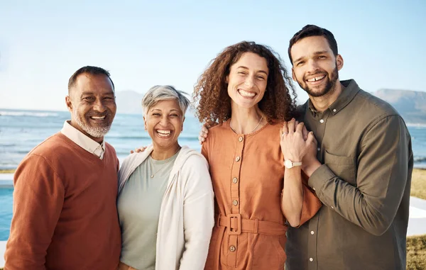 Portrait, couple and elderly parents at beach on holiday, vacation or travel. Face, family men and women at ocean for interracial connection, bonding and funny laugh together, smile and happy outdoor.