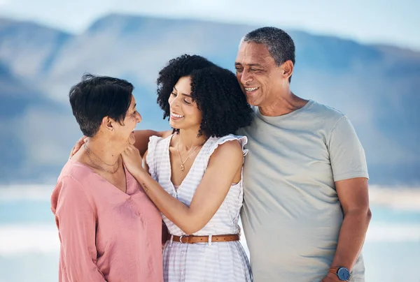 Beach, senior parents and woman in hug together with smile, love and sky on summer holiday in Mexico. Embrace, happy family support and mature mom, dad and woman on ocean holiday travel in nature
