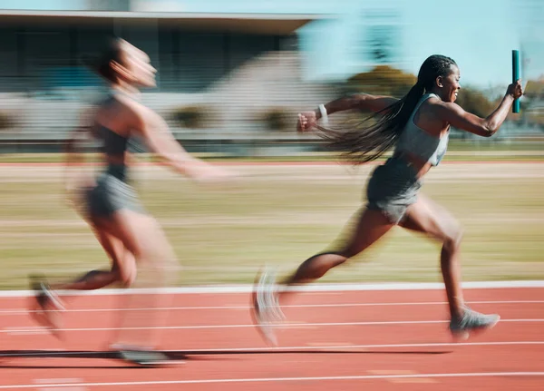 Action, race and women running relay sprint in competition for fitness game and training, energy or wellness on a track. Sports, stadium and athletic people or runner exercise, speed and workout.
