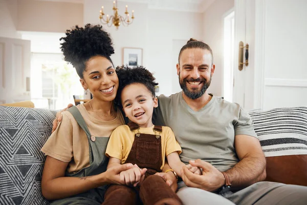 Interracial family, portrait and parents with child relax on couch, bonding and happy together at home. Smile, love and care with trust and support, people in living room, man and woman with kid.