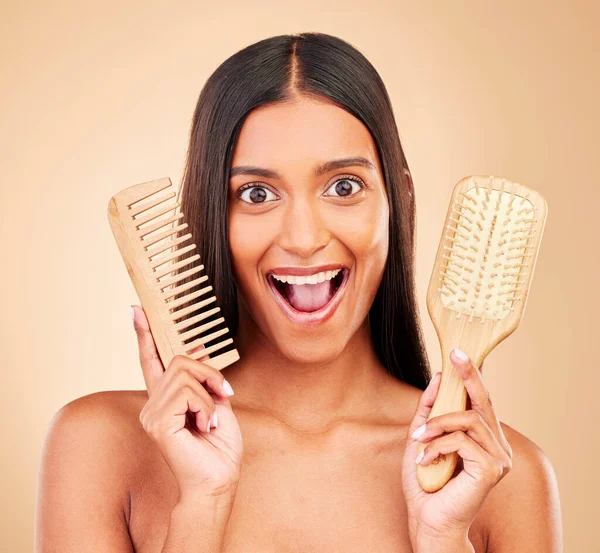 Brush, happy and portrait of woman in studio with clean salon treatment hairstyle for wellness. Beauty, hair care and excited Indian female model with comb for haircut maintenance by brown background.