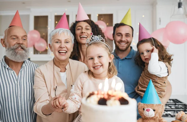 Birthday party, gift and portrait of big family celebrate with cake in home event and candles in a house together. Mother, father and grandparents excited for surprise gathering with children or kids.