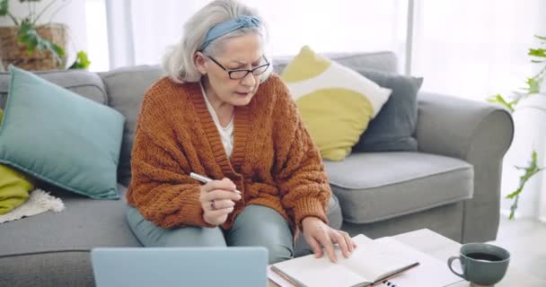 古い女性は 生命保険と退職政策書類でノートブックとノートパソコンで書いています 税金をオンラインで管理し 資産管理文書を自宅で銀行業務を行っています — ストック動画