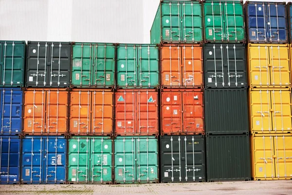 Storage container cargo at harbour ready for import and export. Freight delivery awaiting inspection during shipping crisis by customs before being shipped for distribution. Maritime logistics delay.