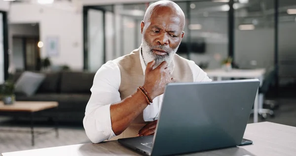 Thinking, laptop and senior business man in office for planning, schedule or management. Idea, solution and elderly African male executive online with plan doubt, problem solving or solution research.