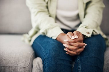 Anxiety, hands and woman on a sofa with stress, fear or worry for mental health or domestic abuse in her home. Psychology, zoom and female with depression, bipolar or scared of gender based violence. clipart