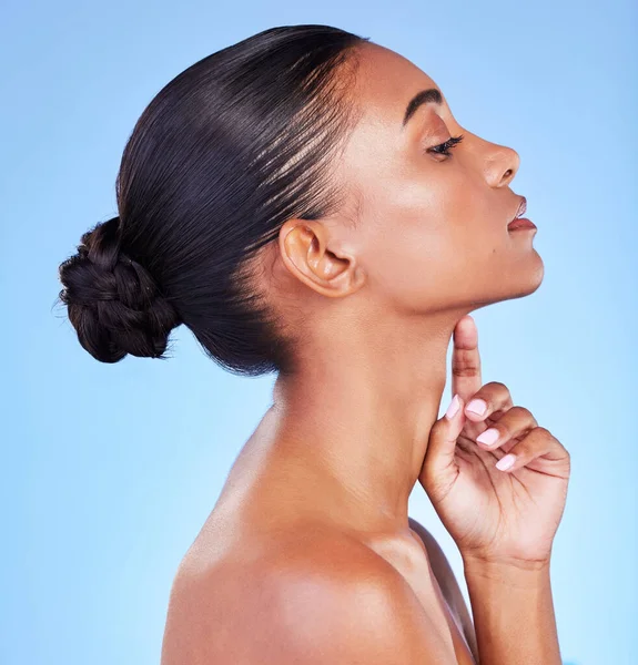 Woman, skin and profile of natural beauty, skincare or shine from cosmetics on blue background in studio with calm model. Dermatology, facial and healthy glow from makeup or wellness from self care.