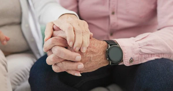 Closeup of old couple, man and woman holding hands for love, care and trust in retirement. Senior partner, loyalty and helping hand for kindness, sorry and support to forgive, hope or empathy at home.