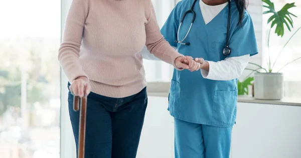 Caregiver hands, disabled and old woman with walking stick for support, senior wellness care or movement disability. Elderly rehabilitation service, retirement home and nurse help patient with cane.