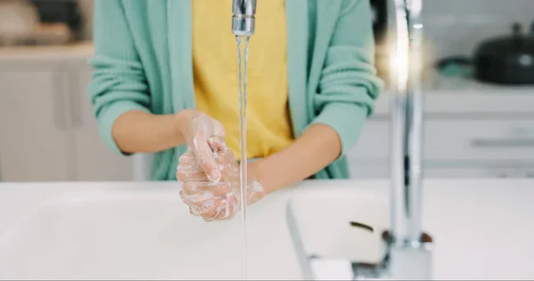 Washing soap, woman hands and kitchen sink of a female with foam for cleaning and wellness. Home, safety and virus protection of a person with sanitary healthcare in a house for skincare and grooming.