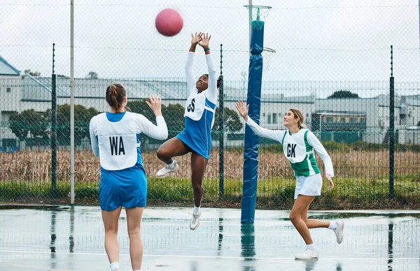 Netball, sports team and woman jump for ball, practice and playing game, court challenge or high school match. Fitness, teamwork and group workout, tournament and player action, exercise or training.