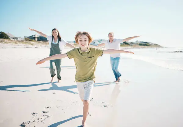 Running, freedom and happy with family on beach for energy, travel and summer vacation. Love, relax and adventure with people playing on seaside holiday for health, bonding and games together.