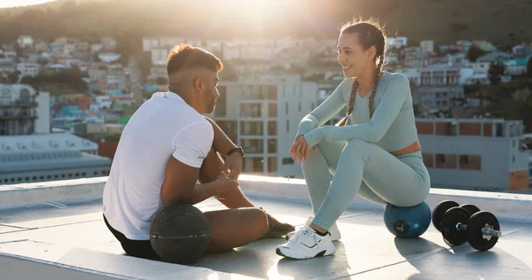 Health, relax and fitness with couple in city for training, sports and support. Wellness, workout and exercise with man and woman on break on rooftop for challenge, teamwork and motivation together.