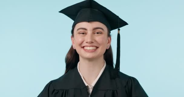 卒業キャップ スタジオフェイス 大学進学 学校教育のプライド 大学の成功のための幸せな女性 青い背景に学生の笑顔の達成 知識研究 肖像画を学ぶ — ストック動画