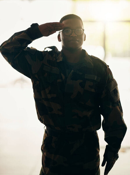 Confident soldier portrait, army and salute in building with pride, professional hero and night service. Military career, security and courage, black man in camouflage uniform at government agency