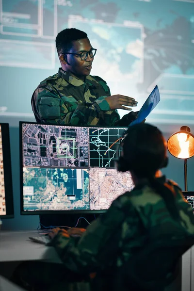 Military control room, computer and woman with team leader, headset and tech in communication. Security, surveillance management and soldier with black man in army office at government command center.