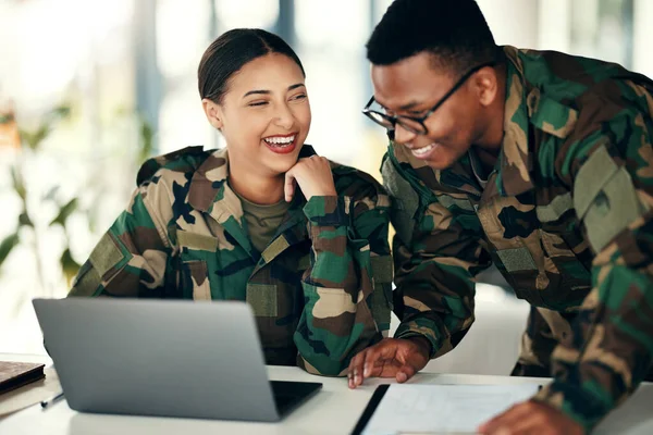 Laptop, friends and an army team laughing in an office on a military base camp together for training. Computer, happy or funny with a man and woman soldier working together on a winning strategy.
