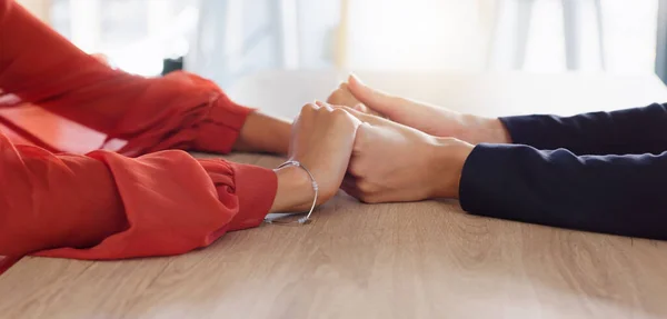Love, empathy and friends holding hands in comfort, support or solidarity during grief, loss or mourning. Depression, mental health and anxiety with two people praying together in trust for help.