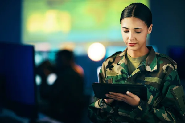 Military, woman and working with tablet in surveillance, control room or technical support for army, officer or mission. USA, cybersecurity and person with online database, research or communication.