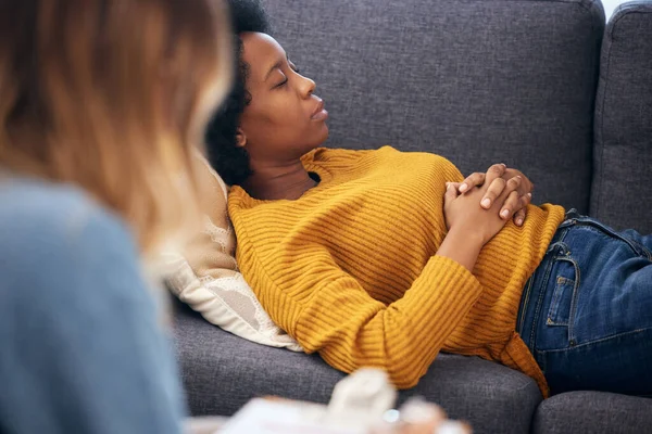 Anxiety, depression and psychology with a black woman in therapy, talking to a professional. Mental health, stress or support with a young patient in session with a psychologist for grief counseling.