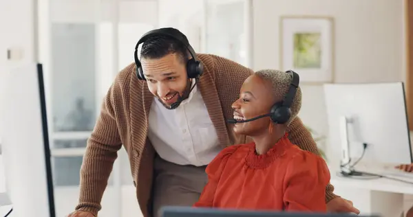 Customer service, happy man training black woman at computer and call center agent internship in office. Coaching, learning and team, manager with telemarketing consultant at desk and help with sales.