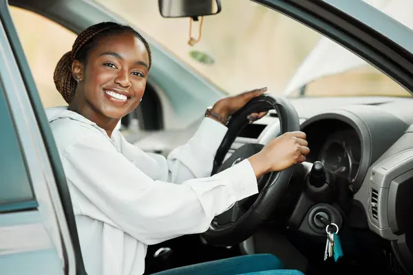 Woman, driving car and portrait in driver seat with license, freedom and travel on road trip. Black female person in automobile, transport or vehicle for test, transportation and excited for journey.
