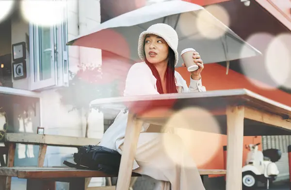 Outdoor, coffee shop and woman relax with drink at cafe, restaurant or patio at bistro with gen z in streetwear or urban fashion. City, style and trendy girl drinking cappuccino in cup with bokeh.